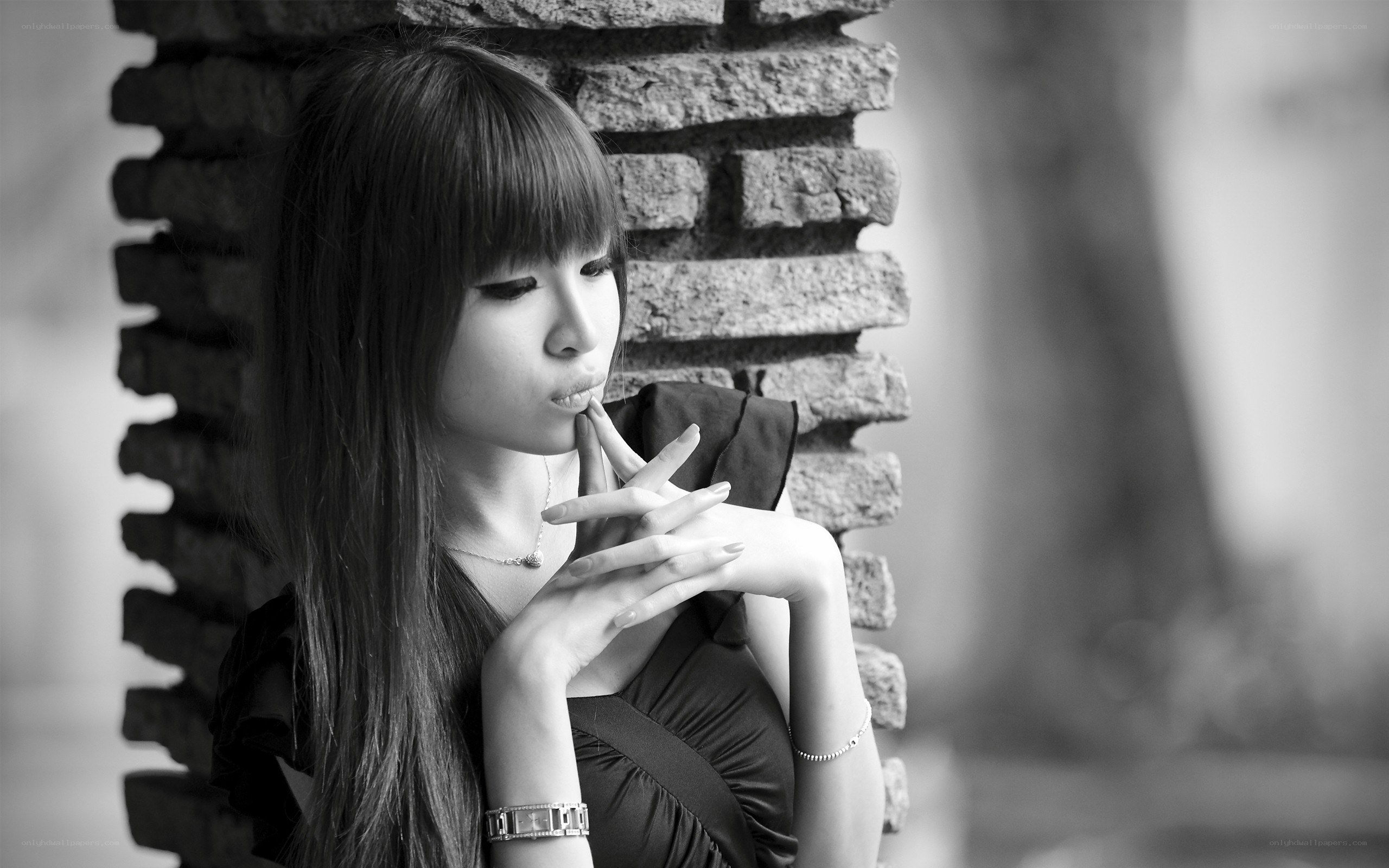 woman leaning against brick wall