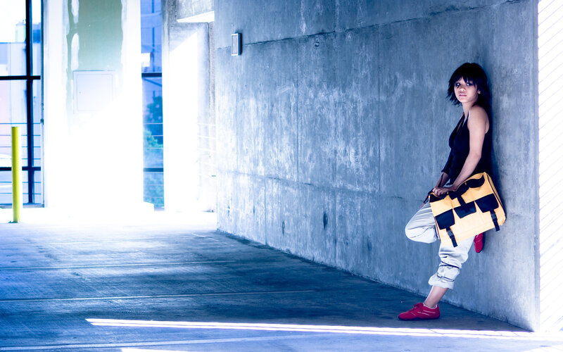 Woman leaning against concrete wall