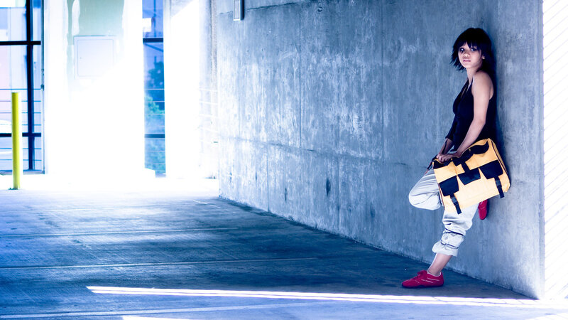 woman leaning against concrete wall