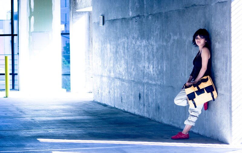 woman leaning against concrete wall