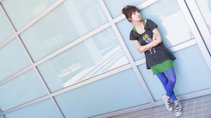 woman leaning against glass wall