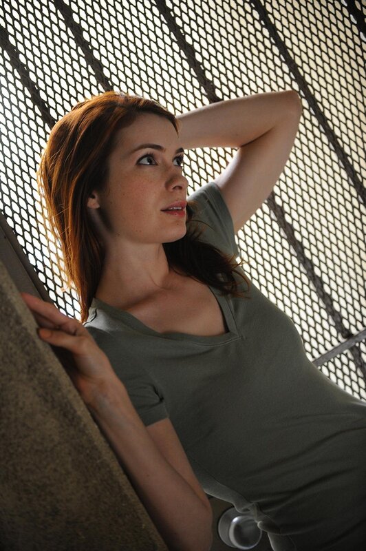 woman leaning against mesh wall