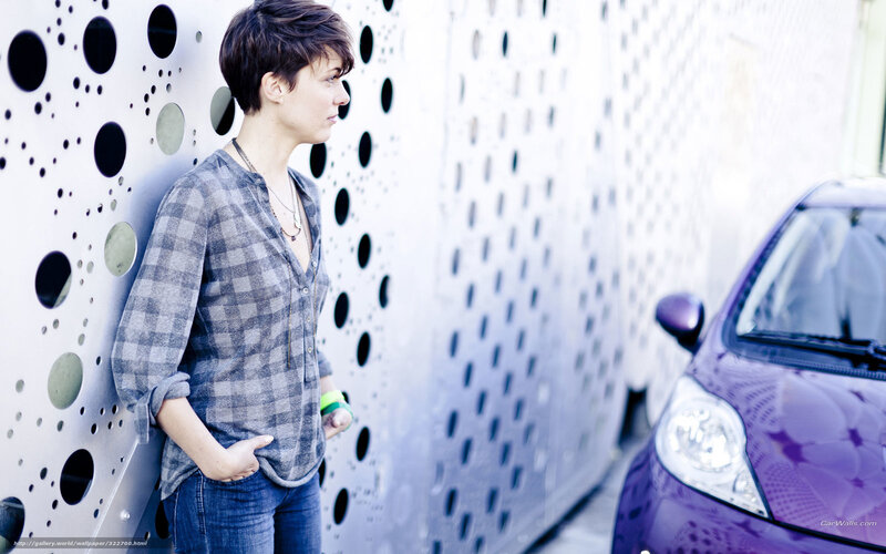 woman leaning against perforated wall