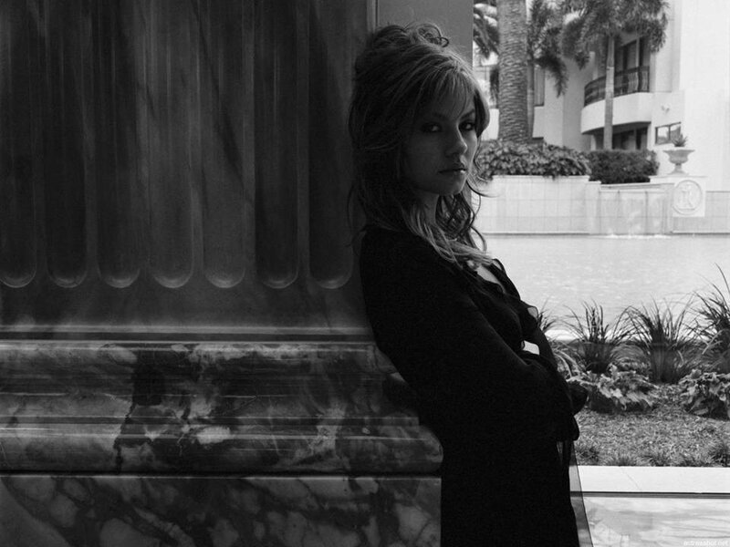 Woman Leaning Against Pillar