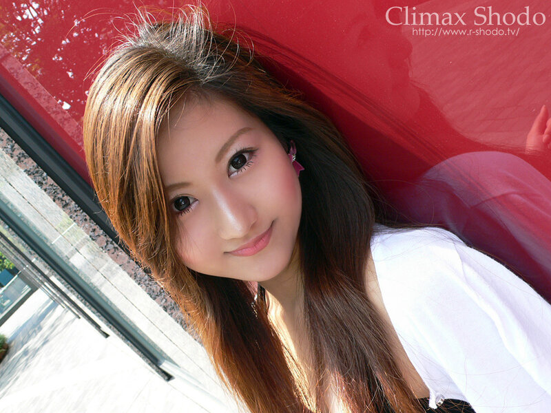 woman leaning against red car