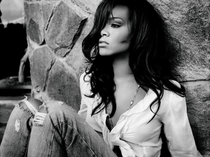 woman leaning against stone wall