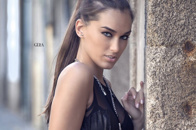 woman leaning against stone wall