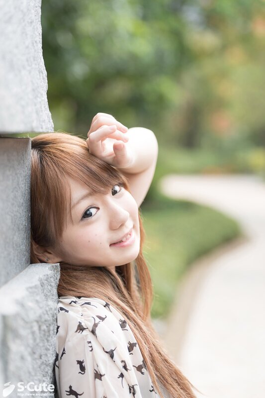 woman leaning against stone wall