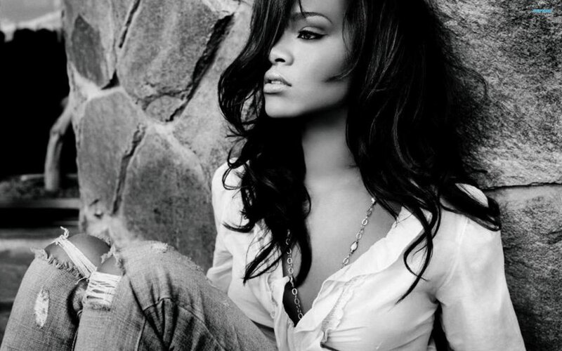 woman leaning against stone wall