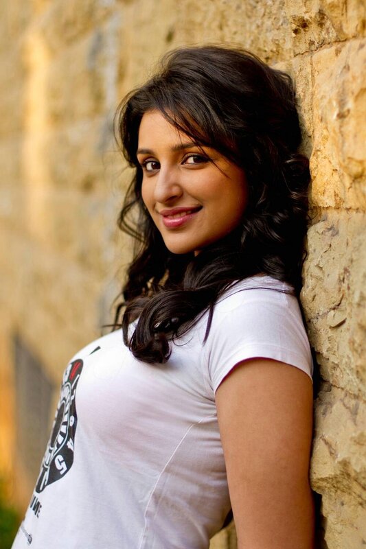 woman leaning against stone wall