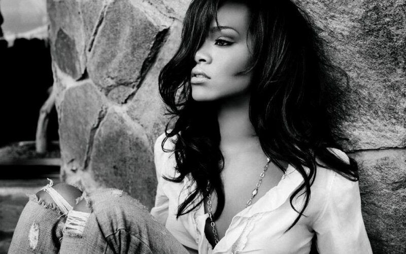 woman leaning against stone wall
