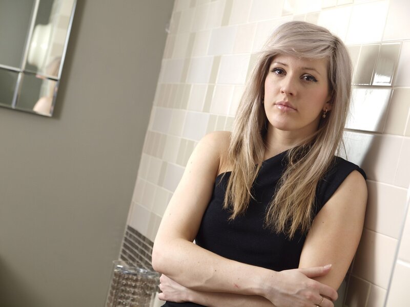 woman leaning against tiled wall