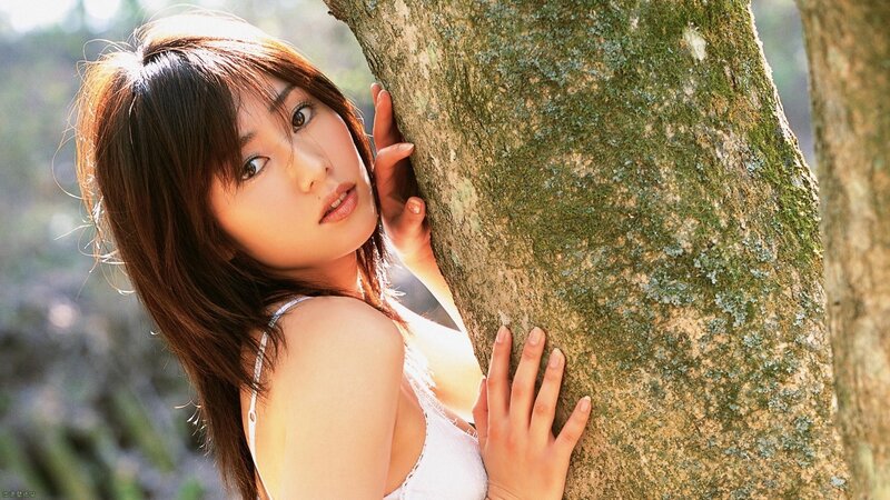 woman leaning against tree