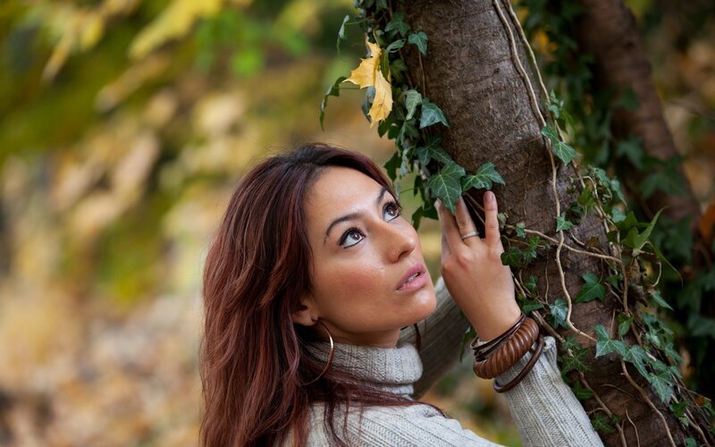 woman leaning against tree