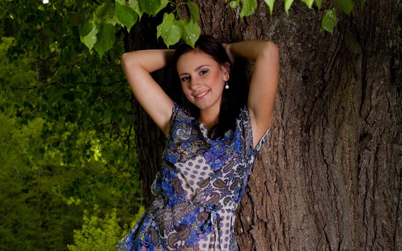 woman leaning against tree