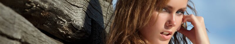 woman leaning against tree