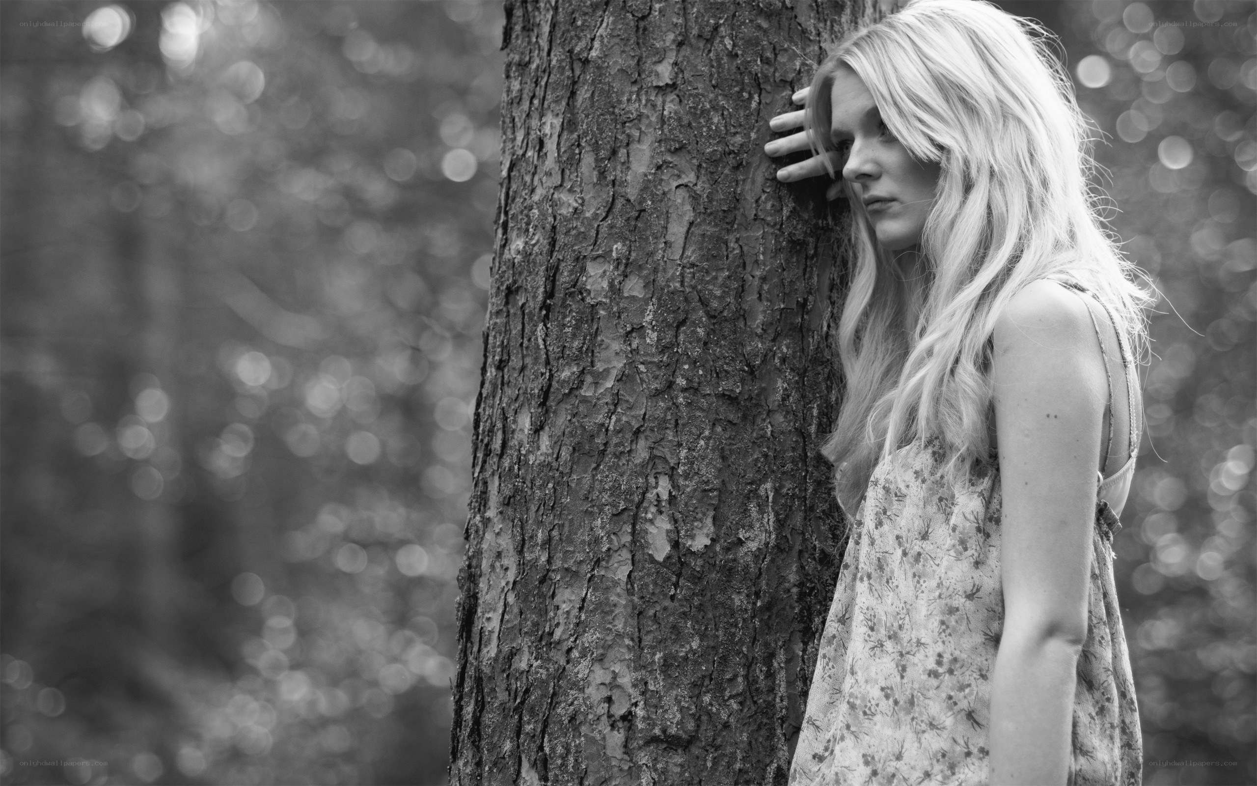 woman leaning against tree