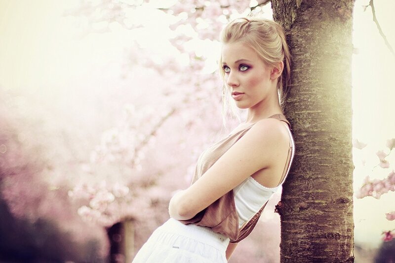 woman leaning against tree