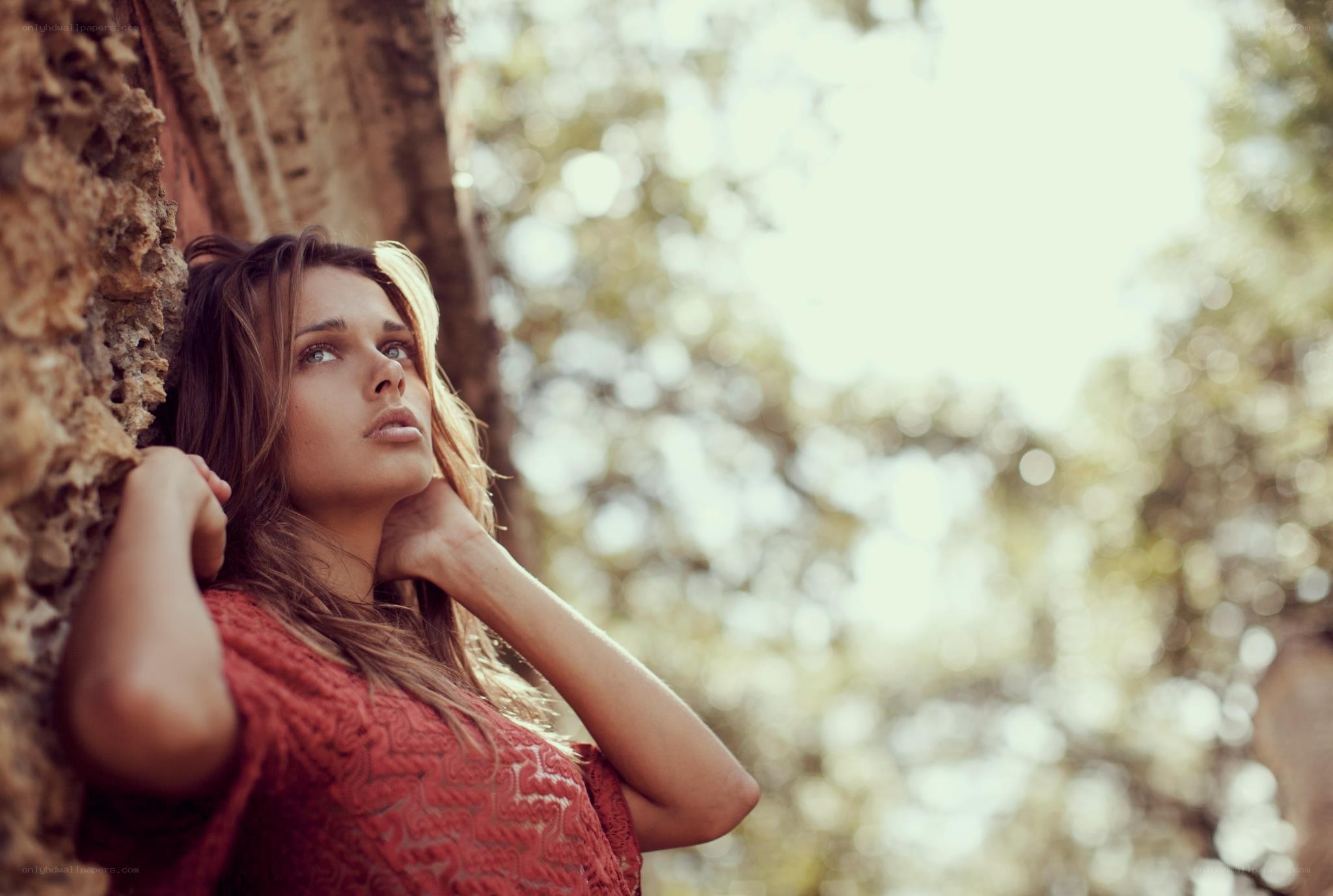 woman leaning against tree