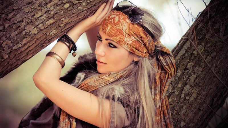 woman leaning against tree