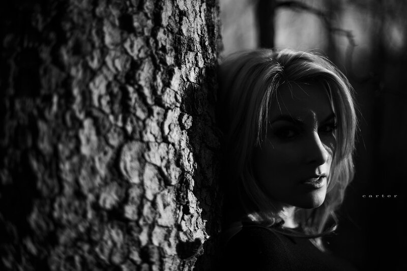 woman leaning against tree