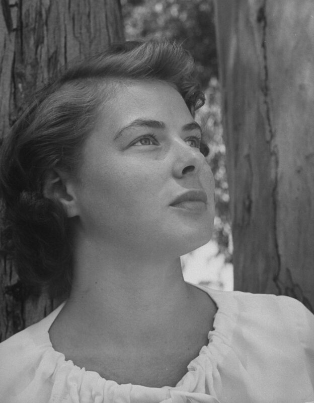 woman leaning against tree
