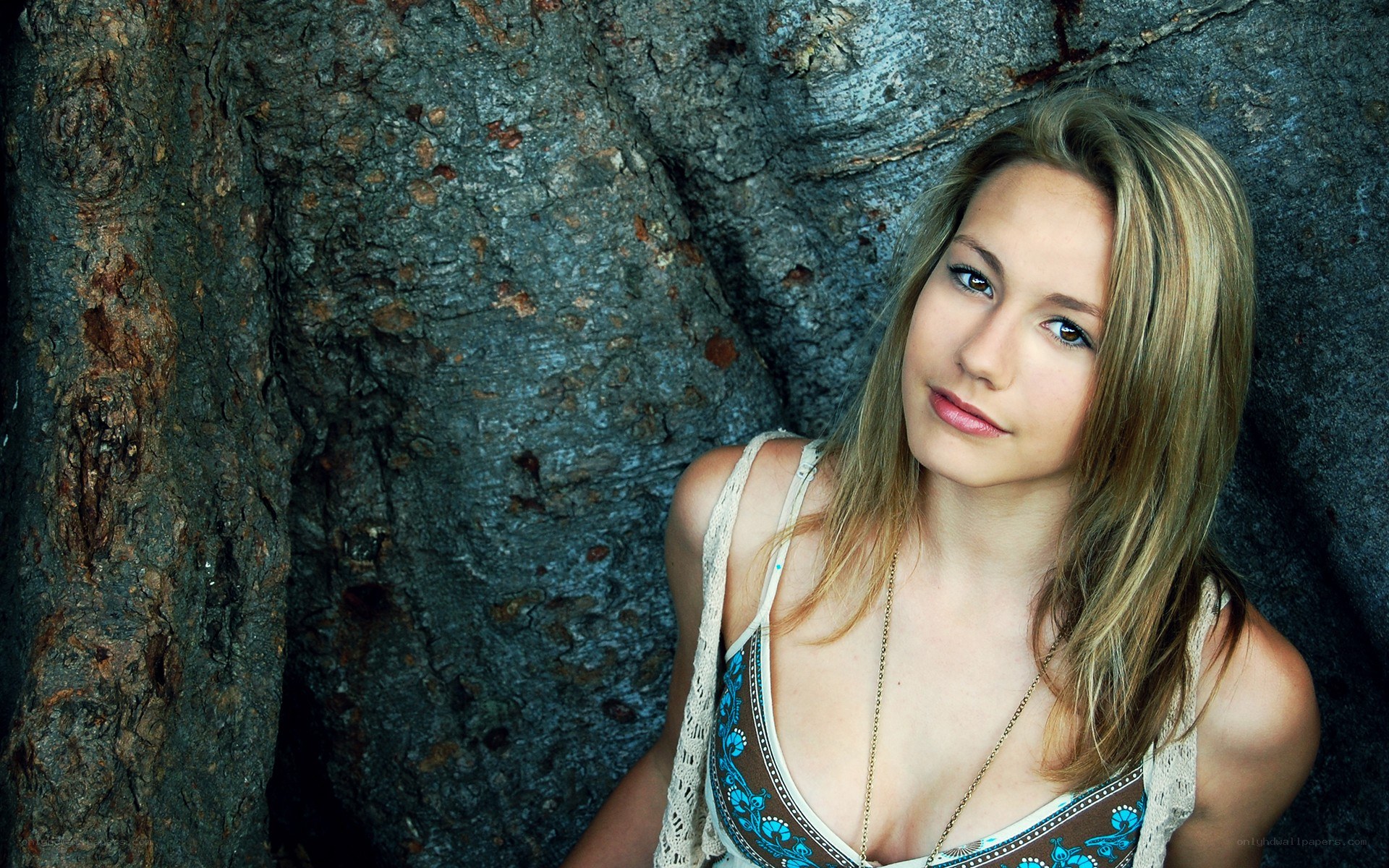 woman leaning against tree