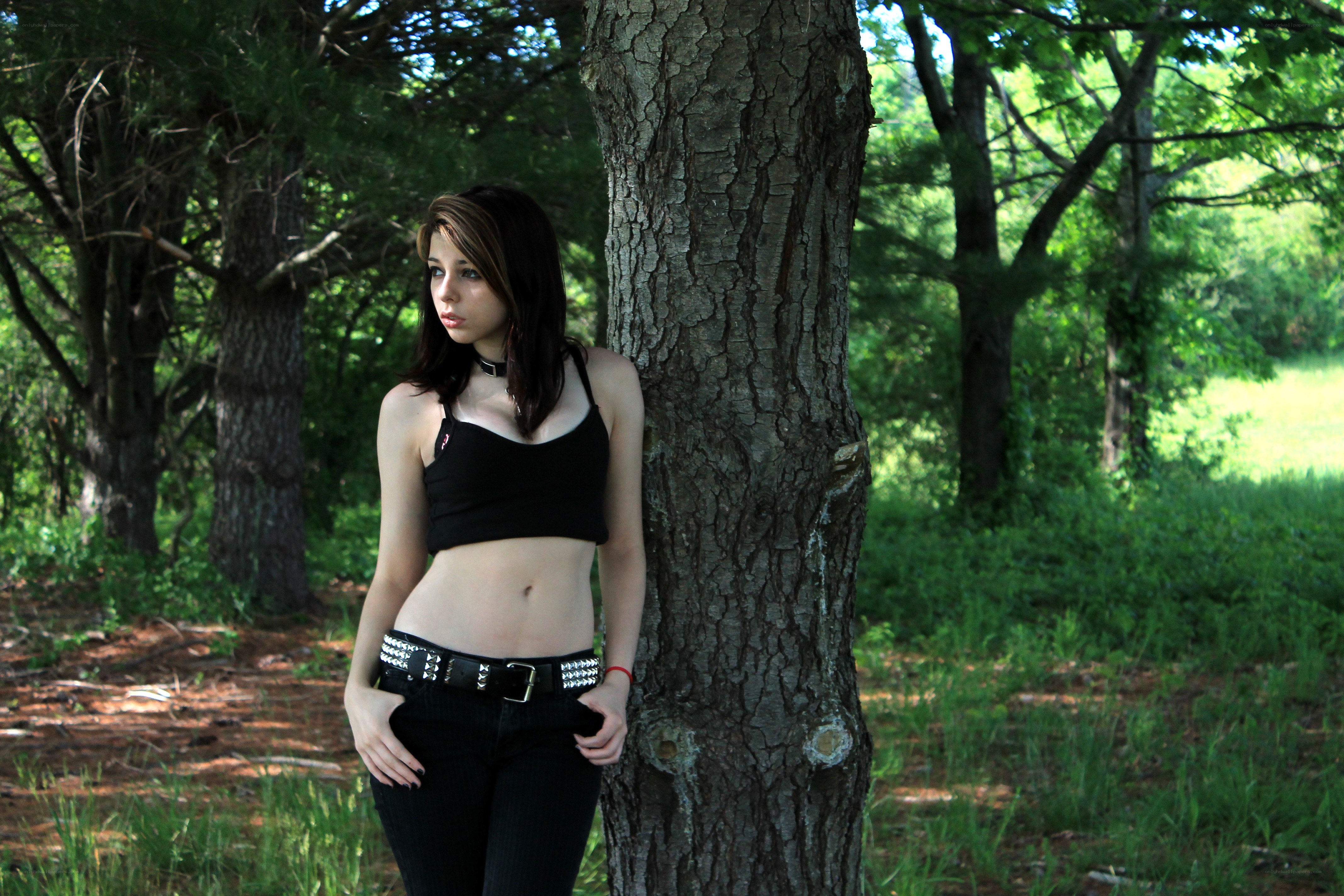 woman leaning against tree