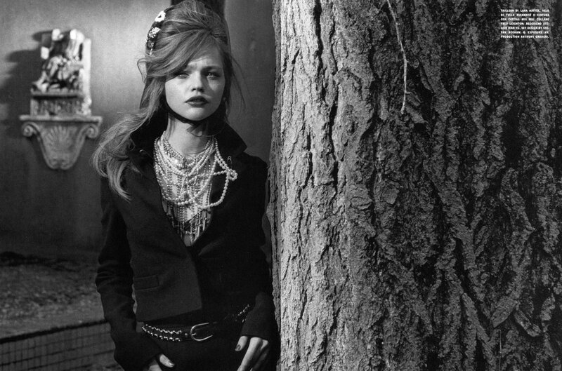 woman leaning against tree