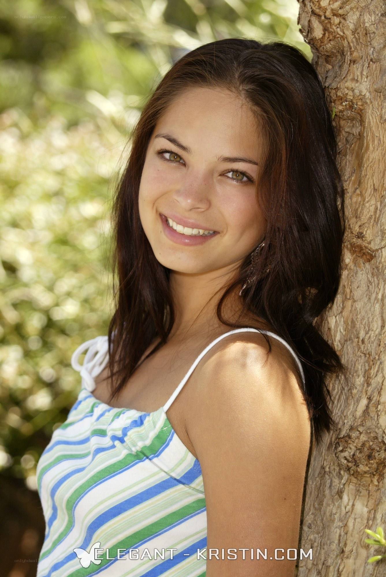 woman leaning against tree