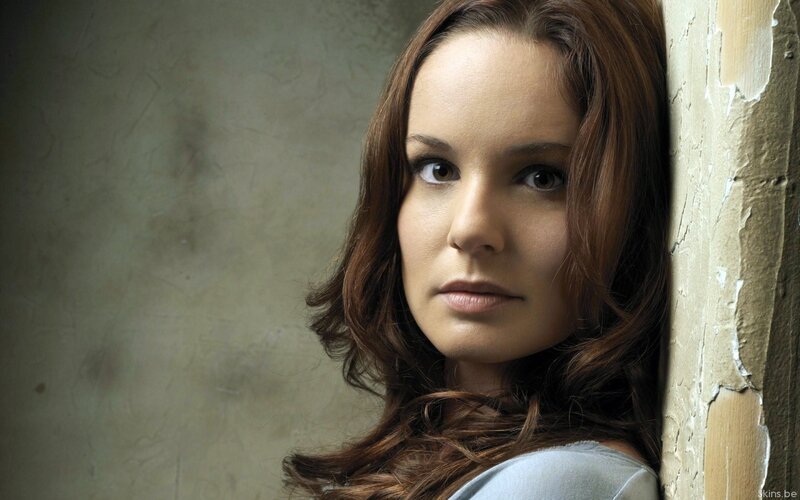 woman leaning against wall