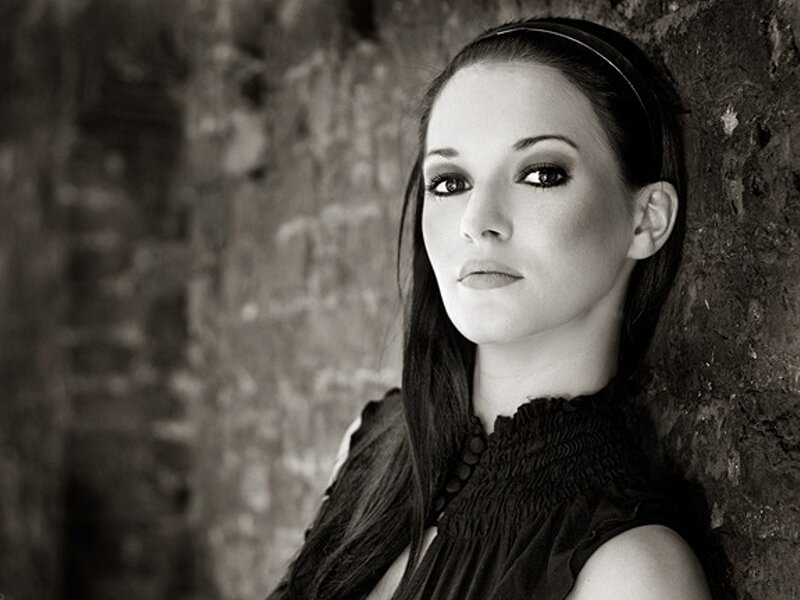 Woman Leaning Against Wall — Black, Serious