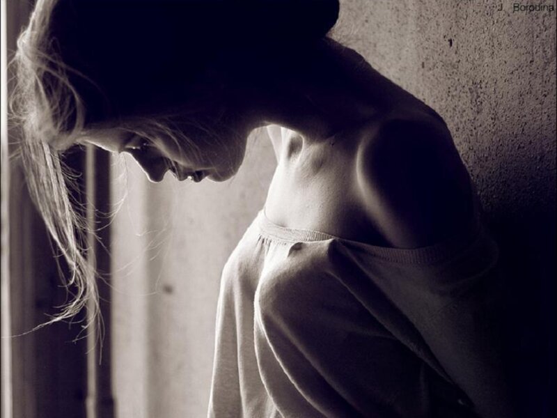 Woman Leaning Against Wall — Black, Somber