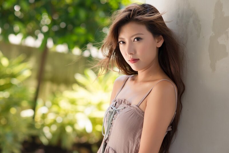 woman leaning against wall outdoors