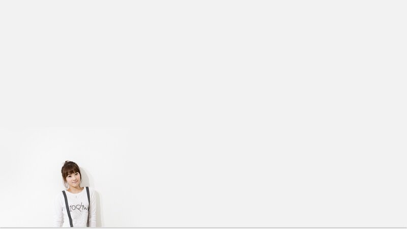 woman leaning against white wall
