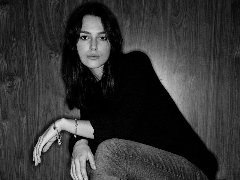 woman leaning against wood wall