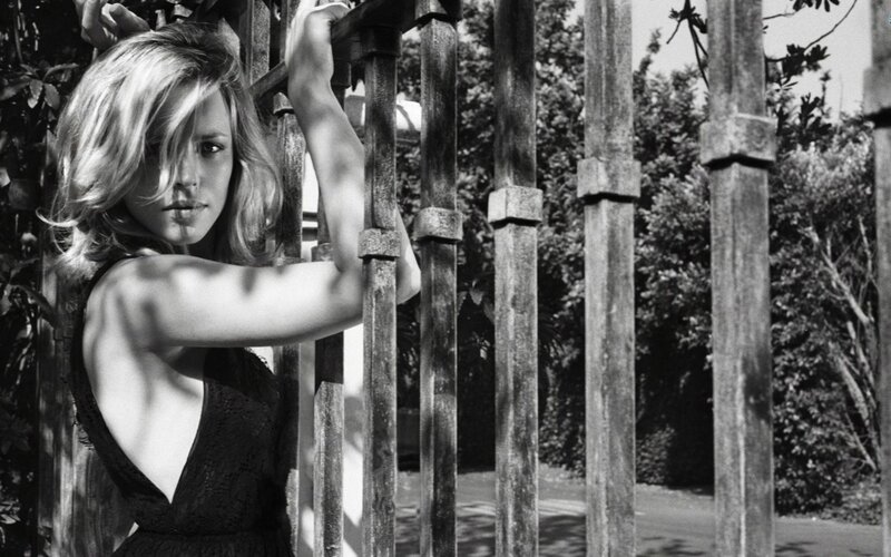 woman leaning on a fence