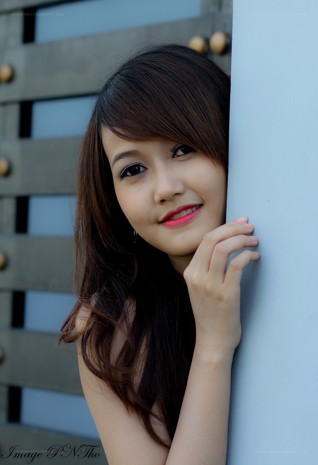 woman leaning on a wall