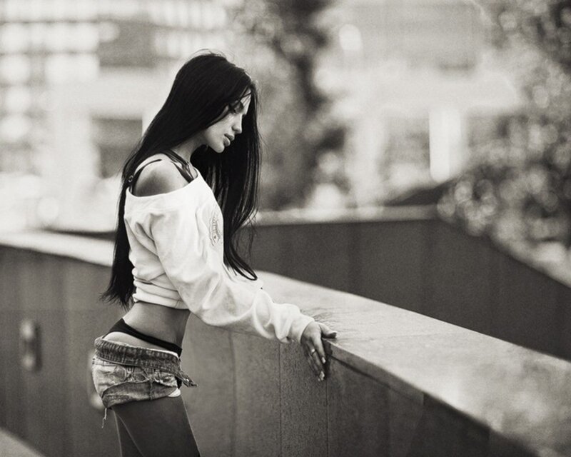 woman leaning on a wall