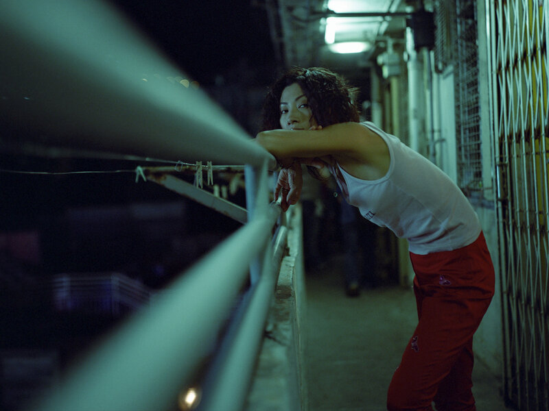 woman leaning on balcony at night