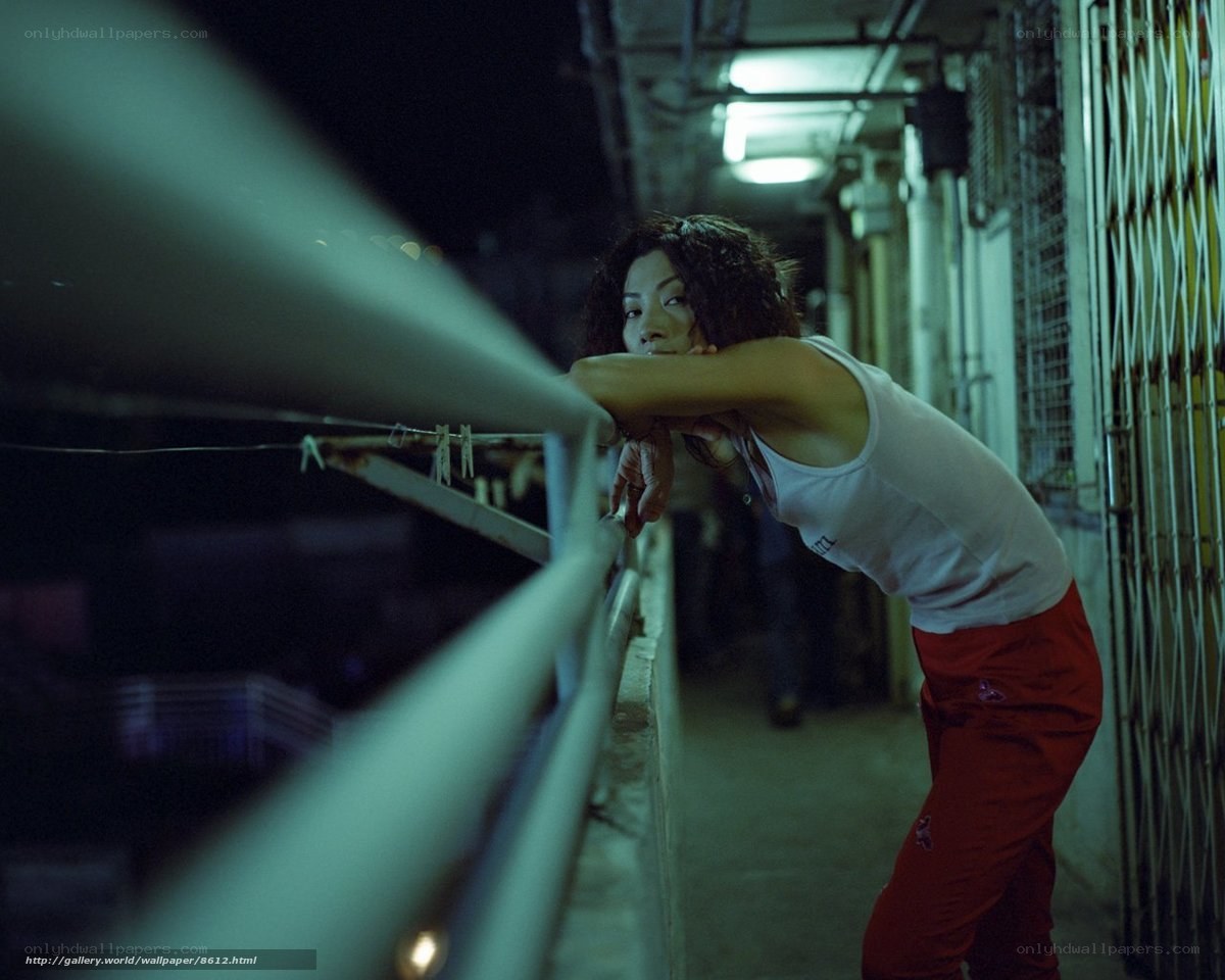 woman leaning on balcony at night