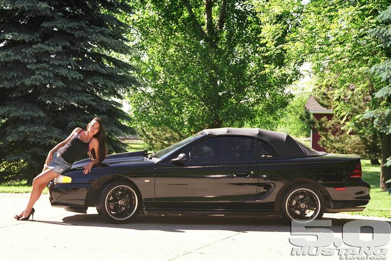 Woman Leaning on Black Car