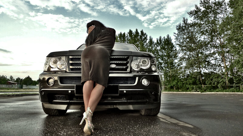 woman leaning on black SUV