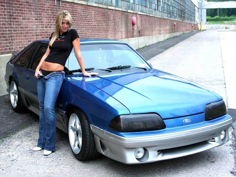 Woman Leaning on Blue Car — Neutral