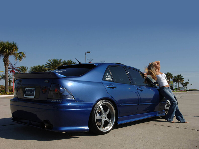 woman leaning on blue car