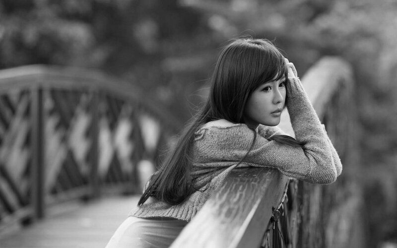 Woman Leaning on Bridge — Black, Contemplative