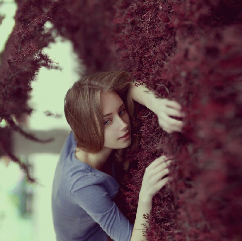 Woman Leaning on Bush