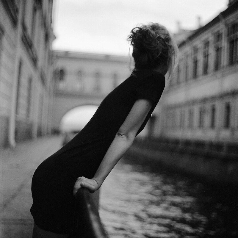 woman leaning on canal railing