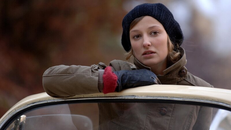 woman leaning on car