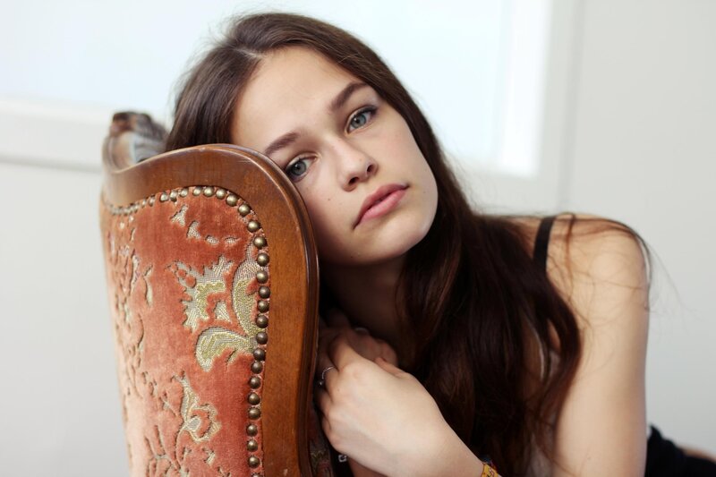 woman leaning on chair